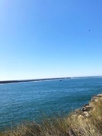 Scenic view of sea against clear blue sky