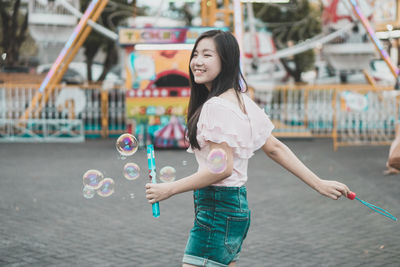 Full length of woman standing at bubbles