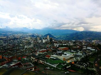 High angle view of cityscape against cloudy sky