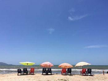 Scenic view of beach against blue sky