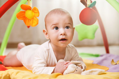 Close-up of baby boy with balloons