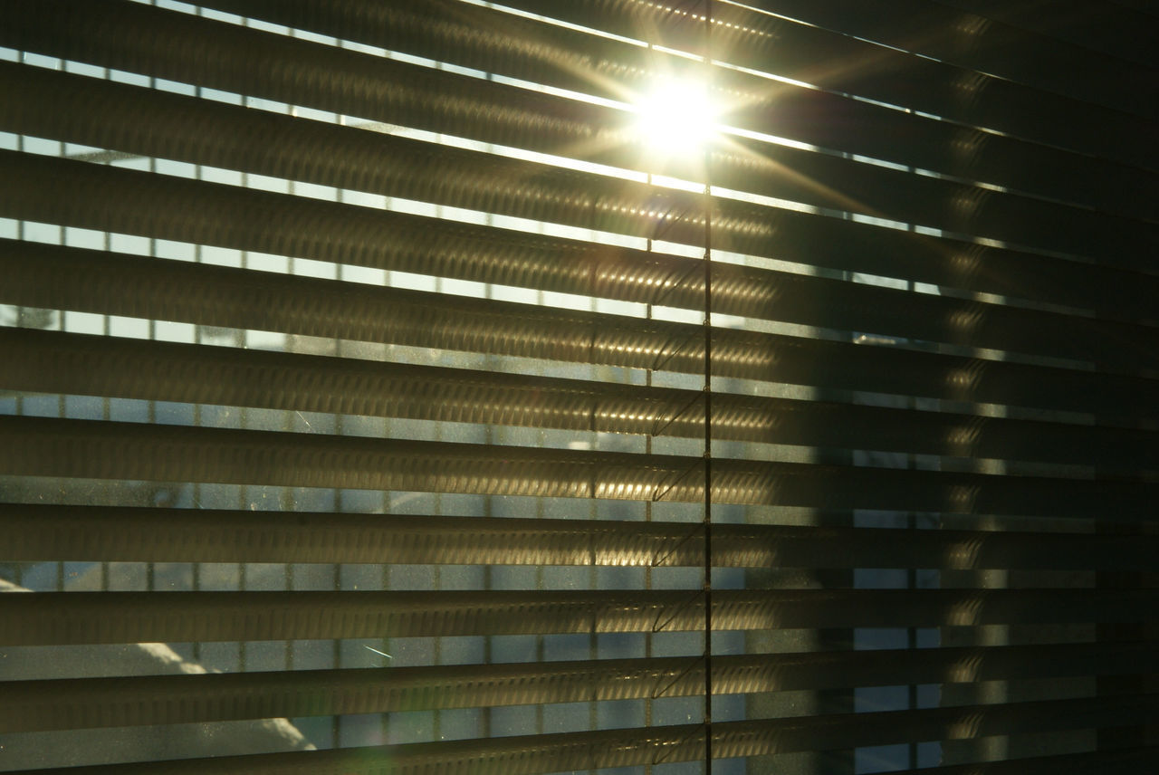 LOW ANGLE VIEW OF SUNLIGHT STREAMING THROUGH WINDOWS