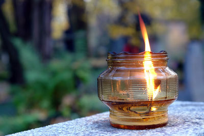 Close-up of lit tea light candle on table