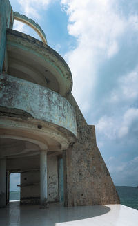 Low angle view of building against cloudy sky