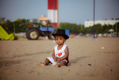 Portrait of young woman sitting at beach