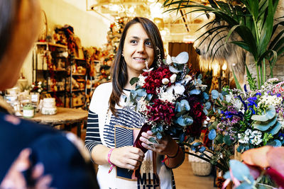 Portrait of smiling young woman standing at home