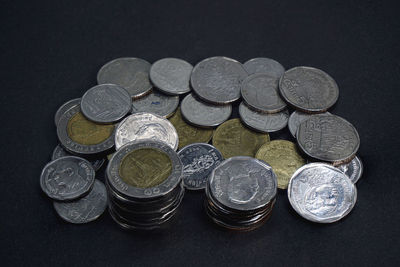 High angle view of coins on black background