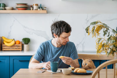 Man having food in kitchen