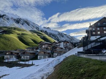 Houses on snowcapped mountains against sky