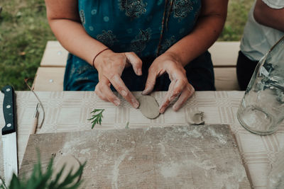 High angle view of woman holding hands on table