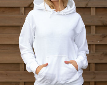 Rear view of woman standing against white wall