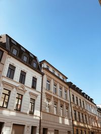 Low angle view of old building against blue sky