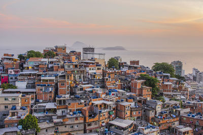 High angle view of townscape by sea against sky