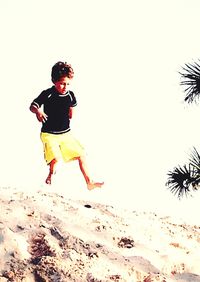 Full length of man jumping on beach