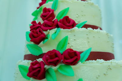 Close-up of roses on wedding cake