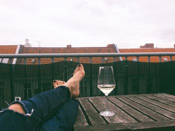 Rear view of woman sitting against sky