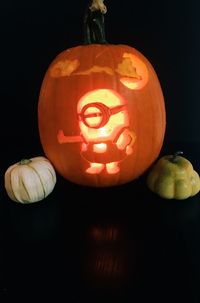 Close-up of illuminated pumpkin against black background