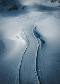 High angle view of people skiing on snow covered mountain