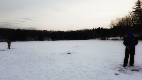 Man on snow field against sky