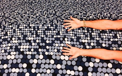 Cropped image of woman hands on bed