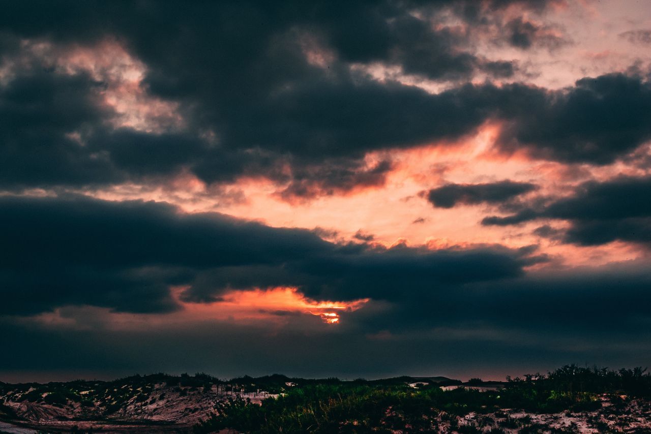 SCENIC VIEW OF STORM CLOUDS OVER LANDSCAPE