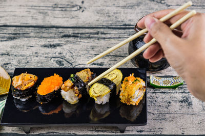 Midsection of person holding sushi