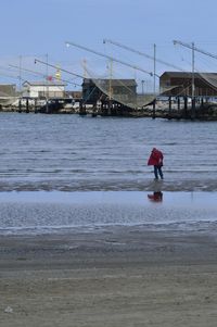 Man on beach against clear sky