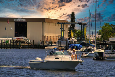 Boat moored at harbor against sky