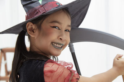 Close-up portrait of a smiling girl looking at camera