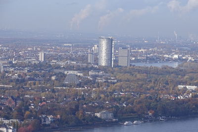 Aerial view of buildings and sea against sky