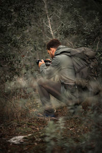 Rear view of man on field in forest