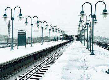 Railroad tracks against clear sky during winter