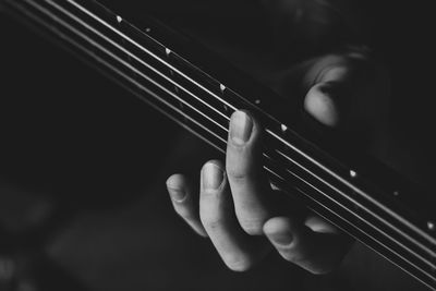 Close-up of man playing guitar