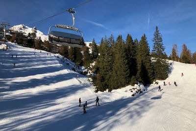 Rear view of man skiing on snow covered landscape