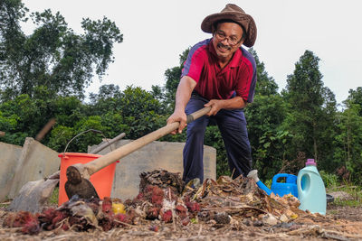 Portrait of smiling man standing against plants