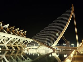 Illuminated bridge against sky at night