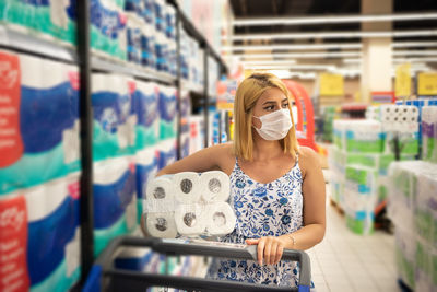 Woman wearing mask shopping at mall