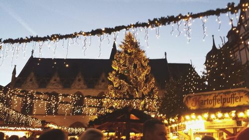 Illuminated christmas tree against sky at night