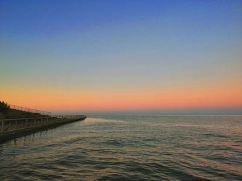 Scenic view of sea against clear sky during sunset