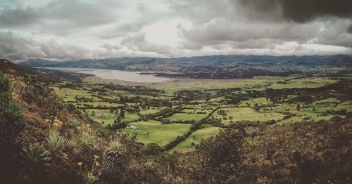 Scenic view of landscape against cloudy sky