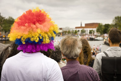 Rear view of man wearing colorful wig