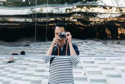 Portrait of woman photographing