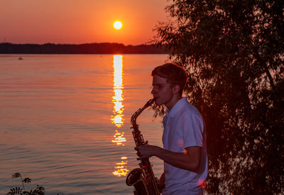 Side view of man standing in lake