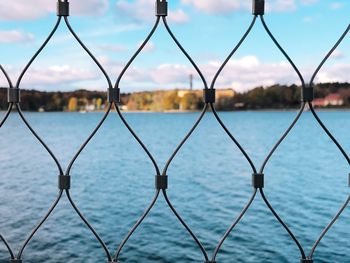 Close-up of chainlink fence against sky