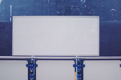 Empty chairs and table against blue wall