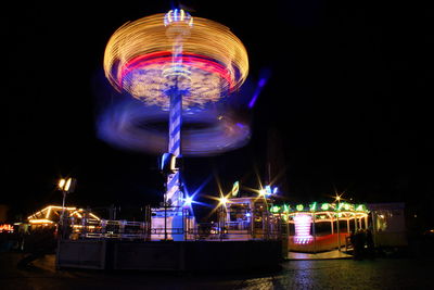 Illuminated ferris wheel at night