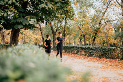 Full length of smiling woman running in park