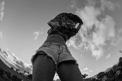 Low angle view of man standing against sky