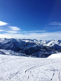 Scenic view of mountains against blue sky