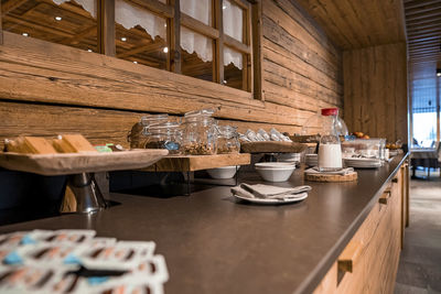 Nutritional food arranged on counter against window at luxurious dining room